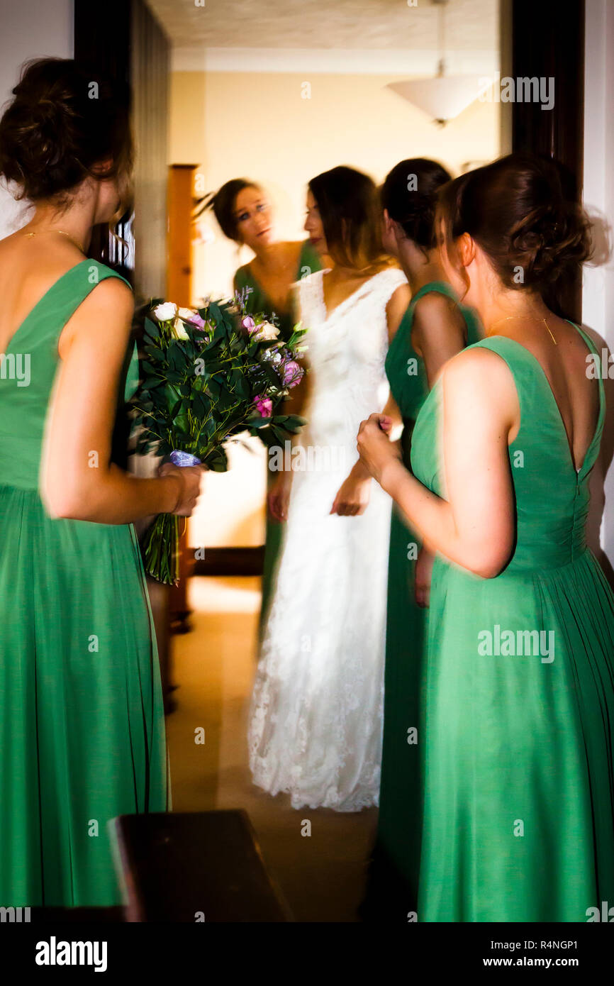 Only the bridal bouquet is not nervous. Bride preparing for wedding with her brides maids Stock Photo