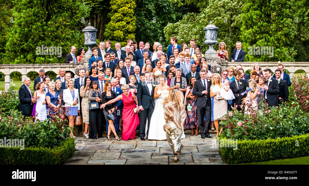 Late arrival at Wedding guests group photo Stock Photo