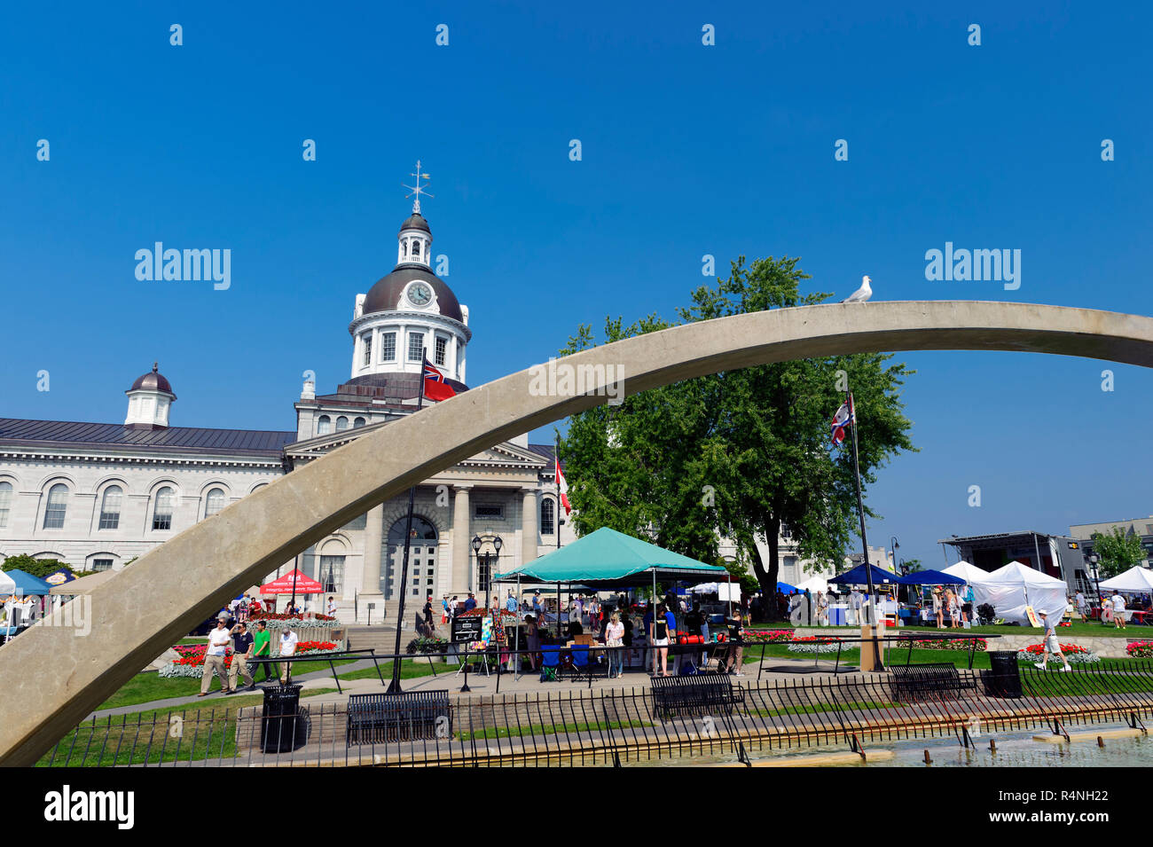 Confederation Park and City Hall, with part of the Confederation Arch in the foreground. Kingston, Ontario, Canada. Stock Photo