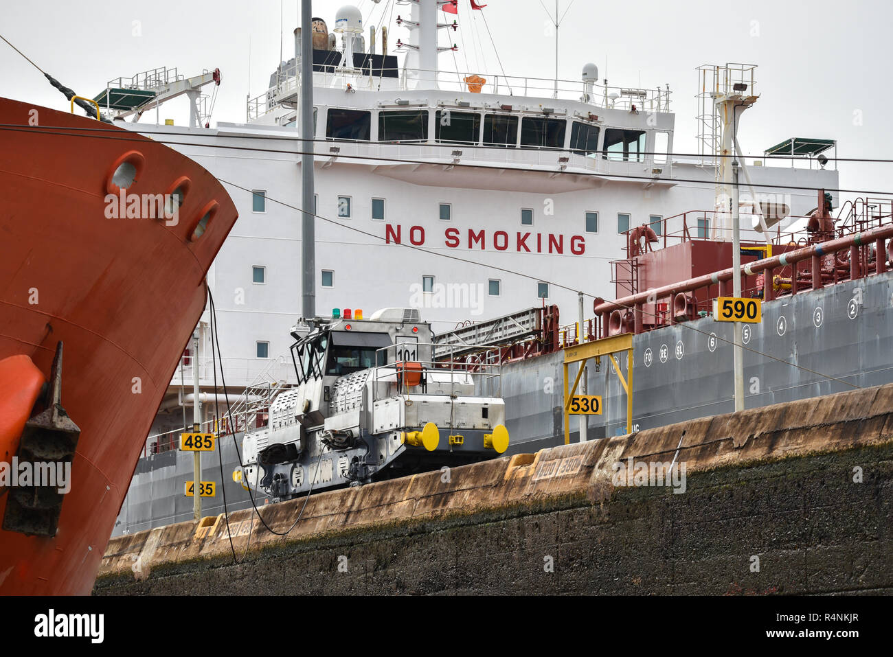 Hazardous habit, Big painted red letter sign on the bridge of a large ocean going ship tells the crew No Smoking. Stock Photo