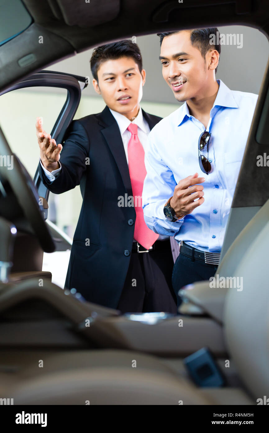 Asian Car Salesman selling auto to customer Stock Photo Alamy