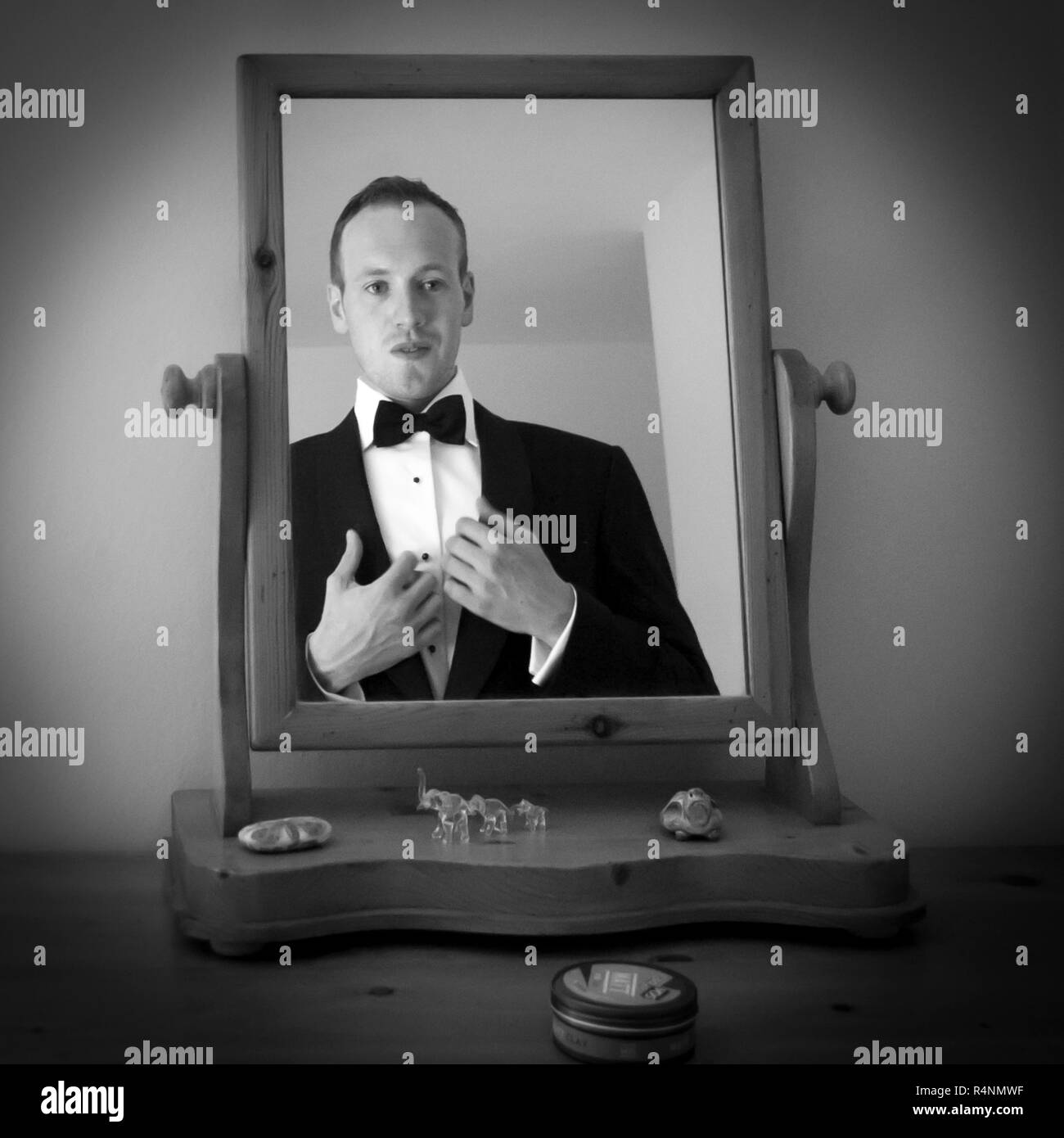 Groom at mirror getting ready for his Wedding Stock Photo