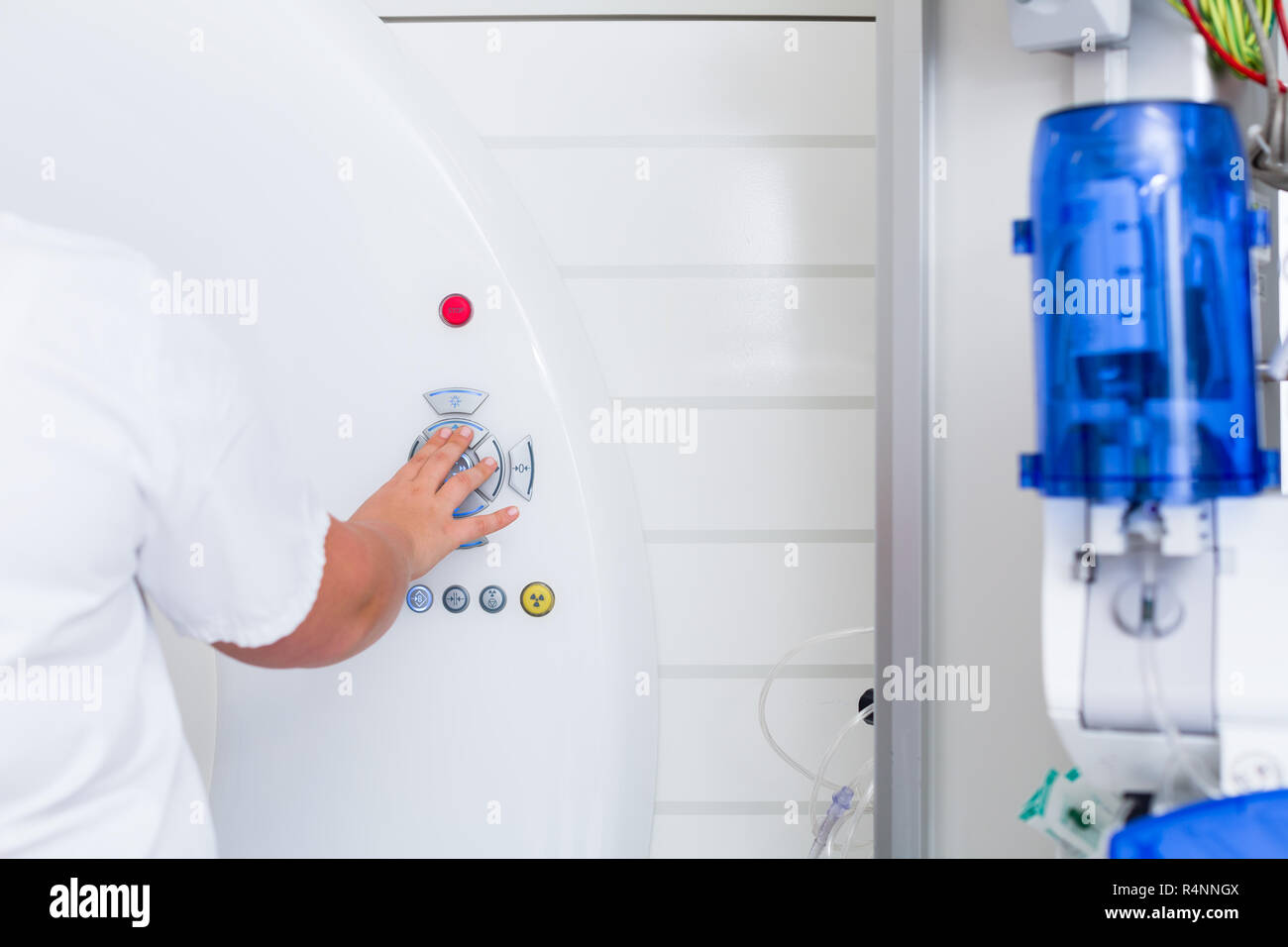 Nurse pressing button on CT machine in hospital Stock Photo - Alamy