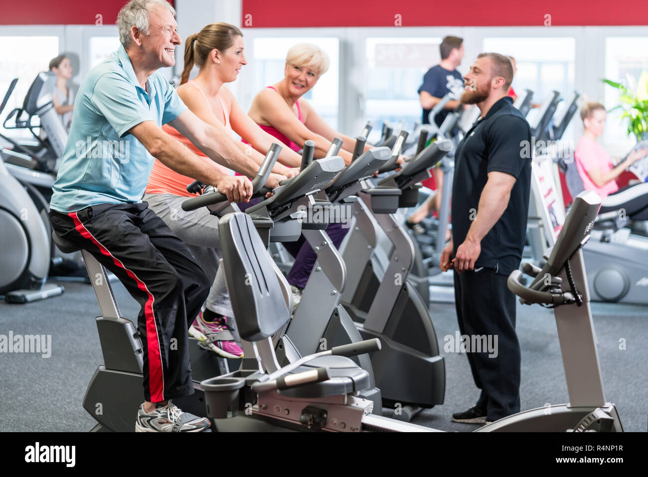 Group spinning with personal trainer in gym Stock Photo Alamy