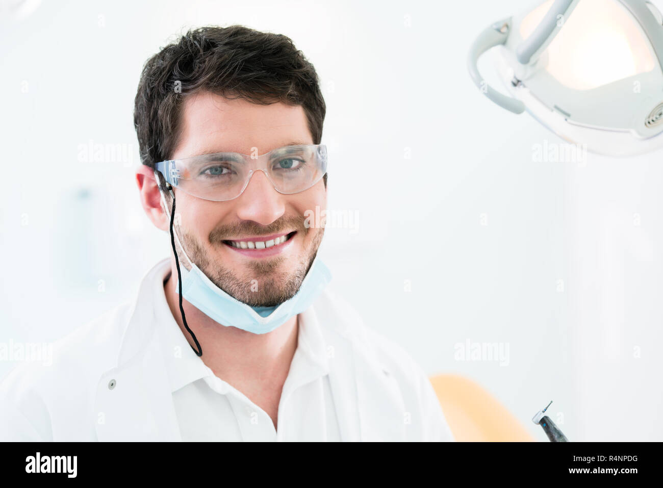Dentist standing in dental surgery Stock Photo Alamy