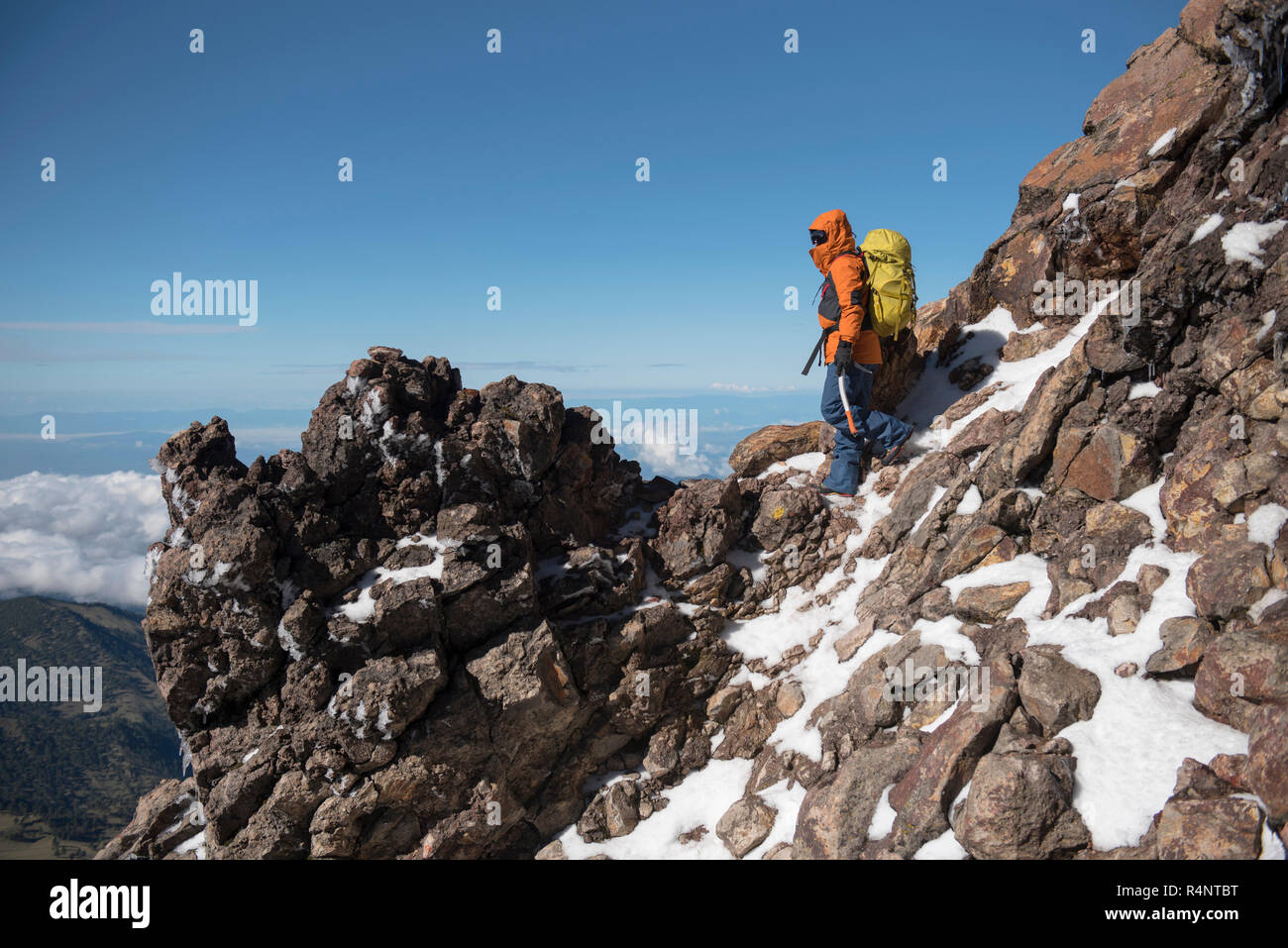 One man stops to watch the landscape while climbing the Iztaccihuatl volcano at theÂ Izta-Popo Zoquiapan National ParkÂ in Puebla, Mexico Stock Photo