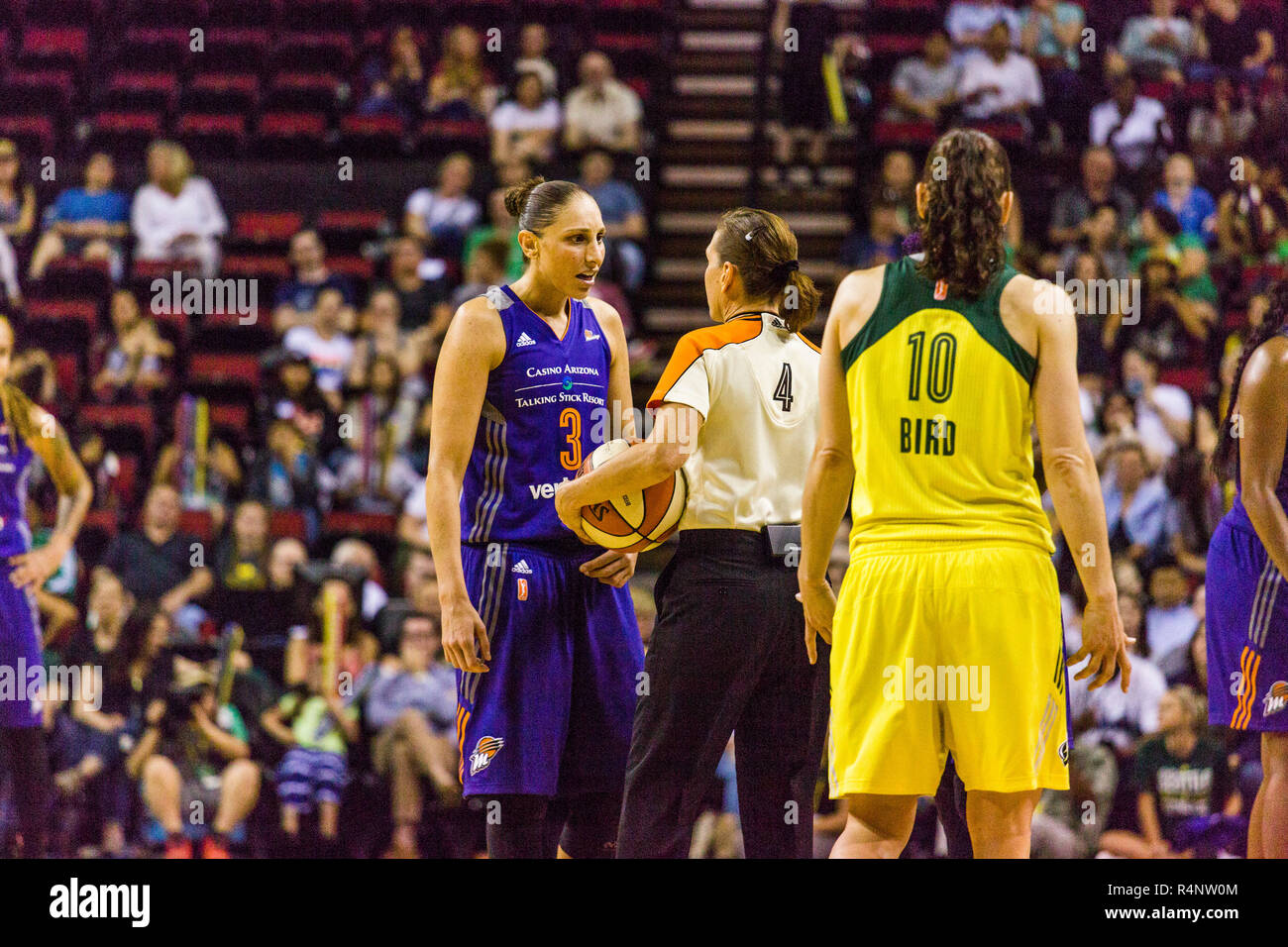 View of female basketball players and referee on court during game, Seattle, Washington State, USA Stock Photo