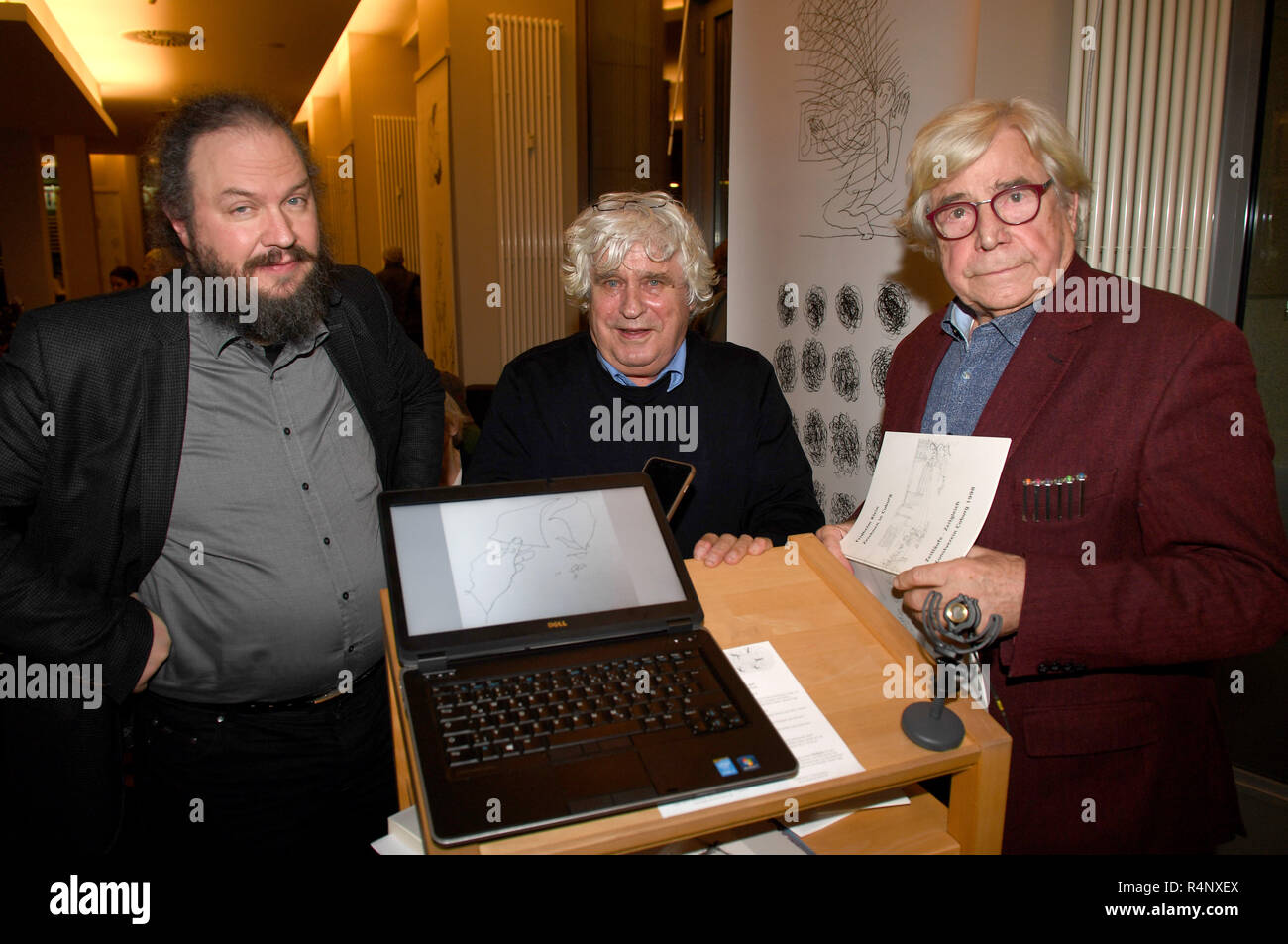 Berlin, Germany. 27th Nov, 2018. The professor of art history Ulrich Heinen, (l-r) the artist Fridhelm Klein and the artist and art theorist Bazon Brock can be seen at an exhibition of the artist Klein in the Denkerei together with a laptop. Credit: Felix Hörhager/dpa/Alamy Live News Stock Photo