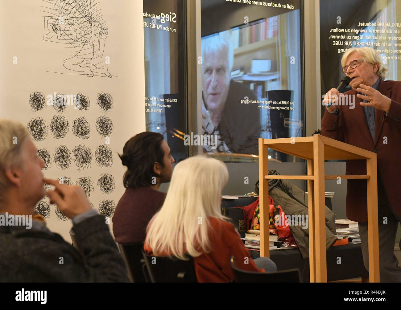 Berlin, Germany. 27th Nov, 2018. The artist and art theorist Bazon Brock (r) speaks at an exhibition of the artist Fridhelm Klein (m, in the projection) in Denkerei. Credit: Felix Hörhager/dpa/Alamy Live News Stock Photo