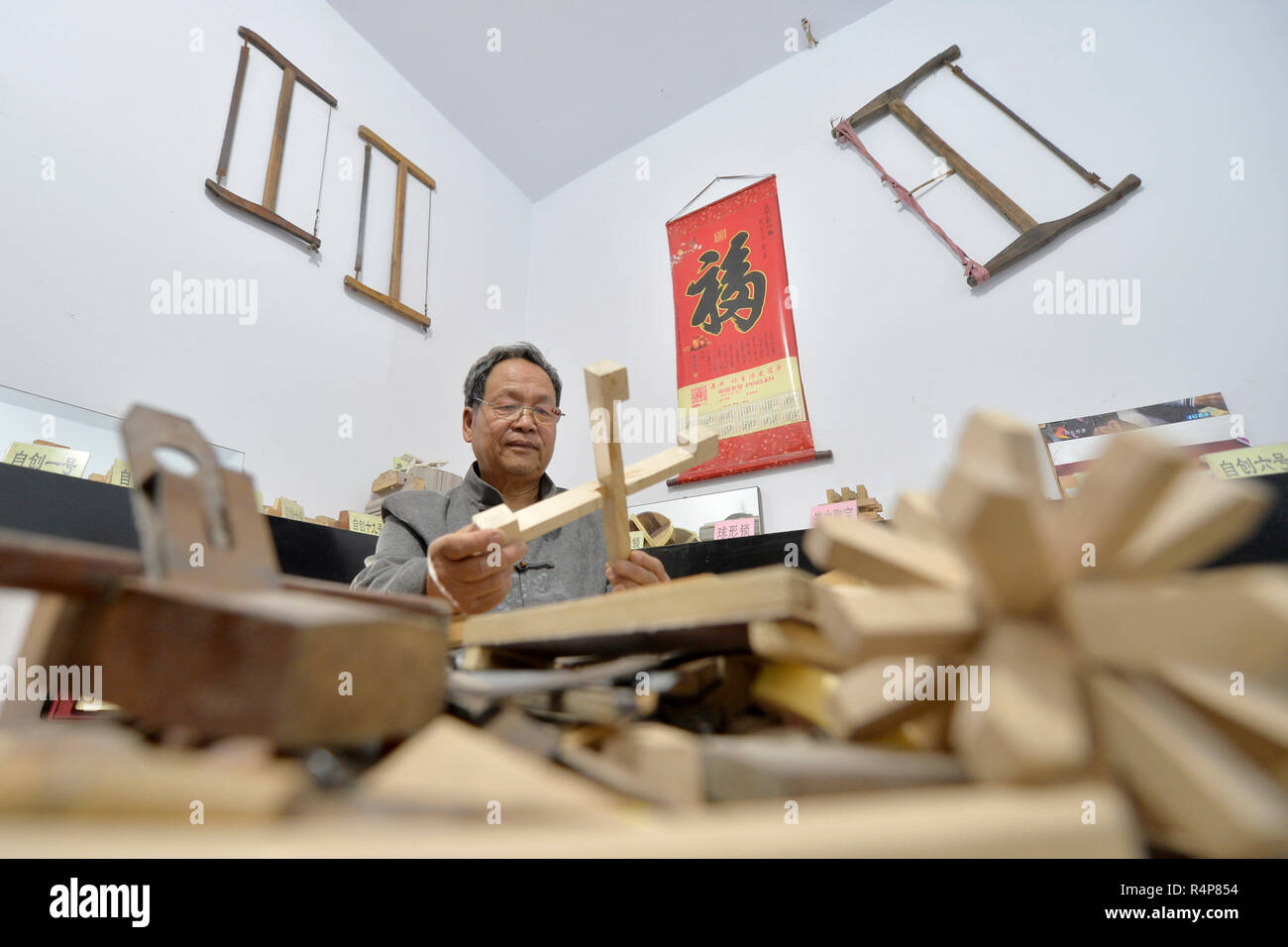 Shahe. 28th Nov, 2018. Hou Quanchen designs a Kong Ming Lock in Shahe City, north China's Hebei Province on Nov. 28, 2018. Hou Quanchen, who is in his seventies, has devoted himself in the studying and making of Kong Ming Locks and has tried to promote this art among local residents ever since his retirement. Credit: Tian Xiaoli/Xinhua/Alamy Live News Stock Photo