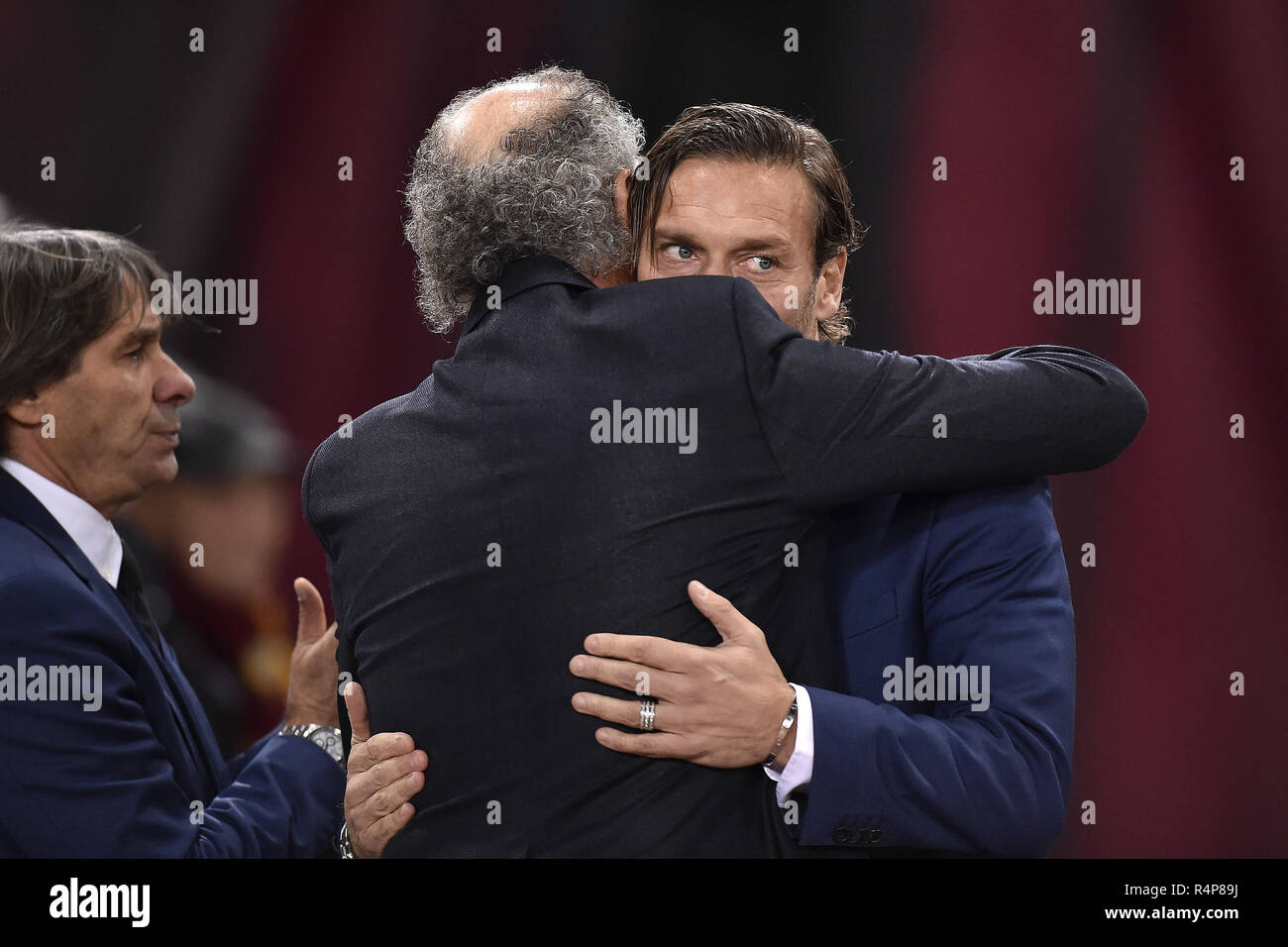 Rome, Italy. 27th Nov 2018. AS Roma former player Francesco Totti hugs AS Roma former player Paulo Roberto Falcao before the UEFA Champions League match between Roma and Real Madrid at Stadio Olimpico, Rome, Italy on 27 November 2018. Credit: Giuseppe Maffia/Alamy Live News Stock Photo