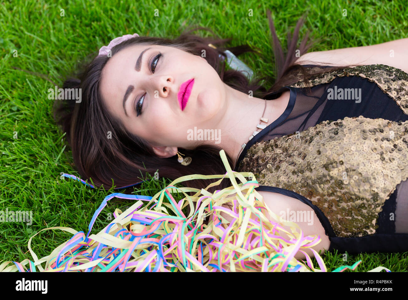 Drunk girl lying on the lawn after bachelorette party Stock Photo