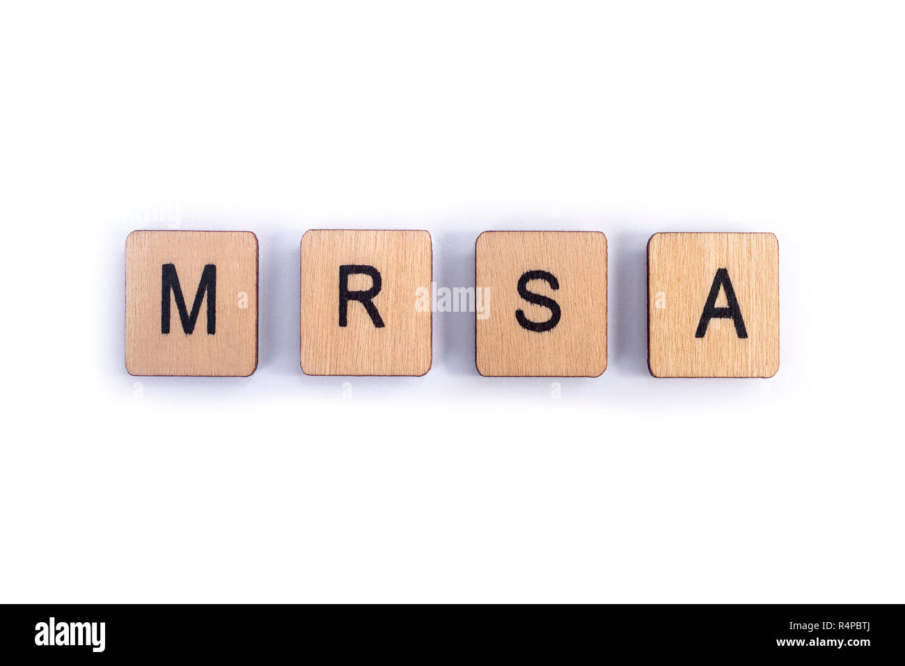 The abbreviation MRSA - Methicillin-resistant Staphylococcus aureus, spelt with wooden letter tiles. Stock Photo