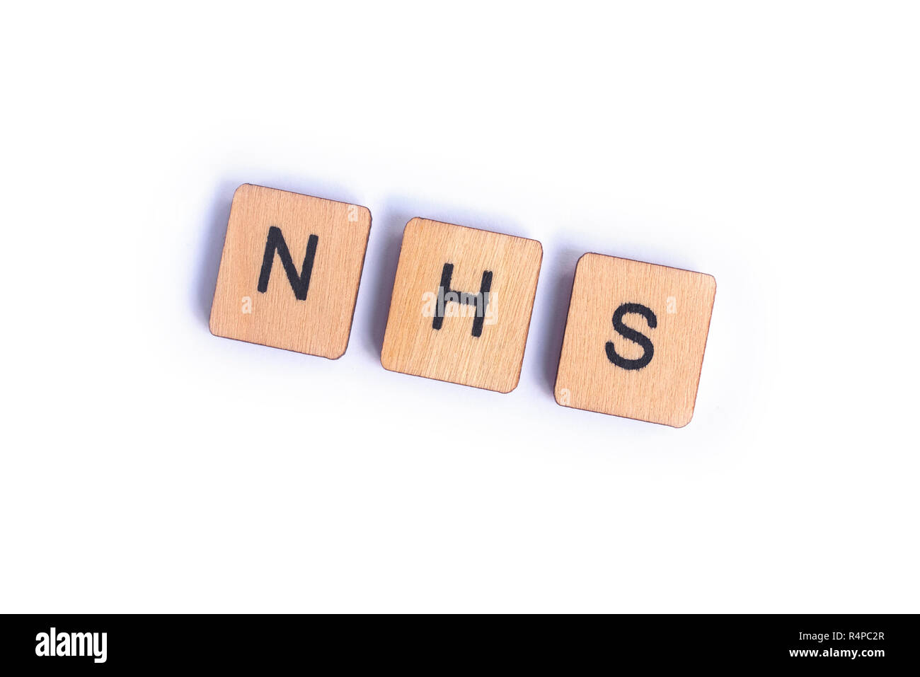 LONDON, UK - JULY 7TH 2018: The abbreviation NHS - National Health Service - spelt with wooden letter Scrabble tiles, on 7th July 2018. Stock Photo