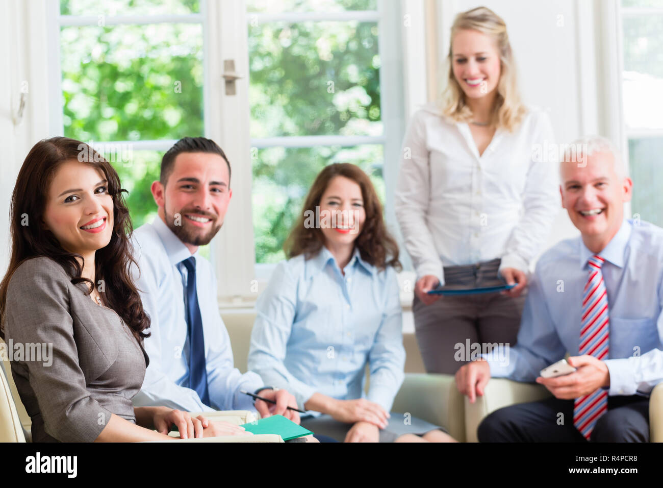 Business women and men in office having presentation Stock Photo - Alamy