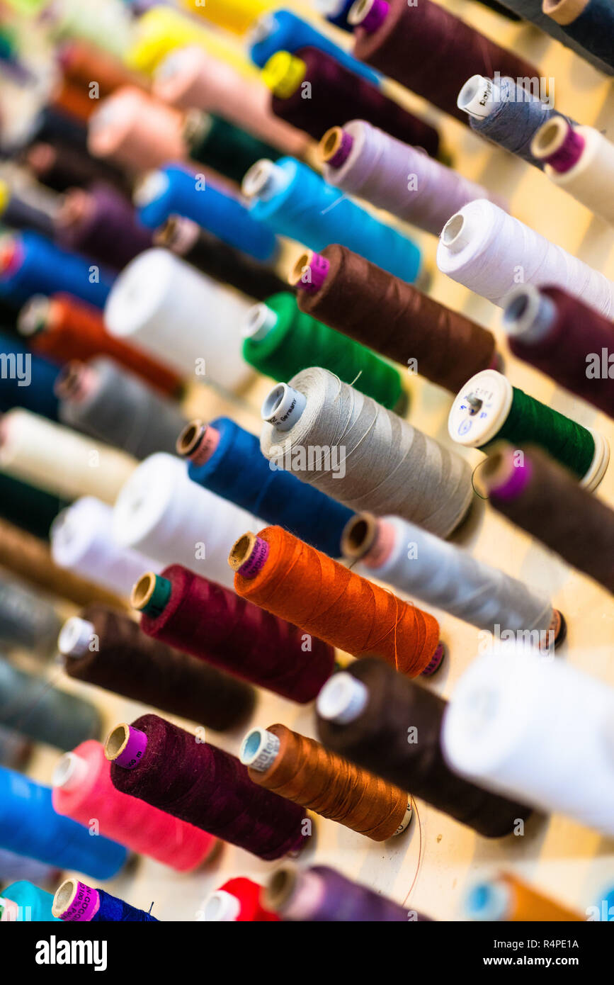 Sewing thread on bobbins in tailor shop Stock Photo Alamy