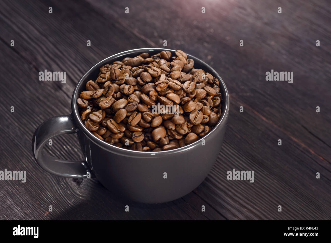 Coffee beans in coffee cup on background Stock Photo