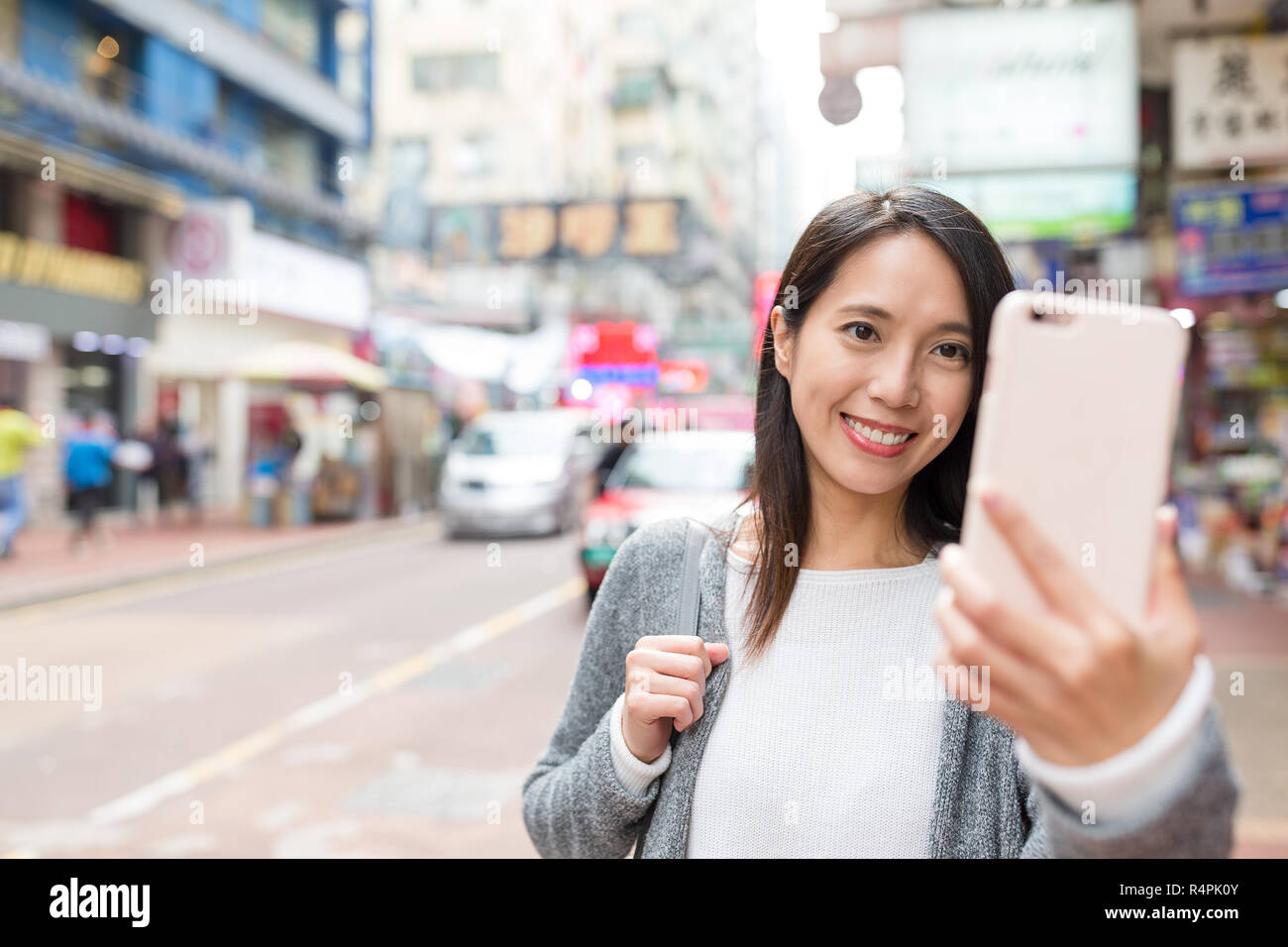Woman taking selfie by cellphone in Mongkok city of Hong Kong Stock ...