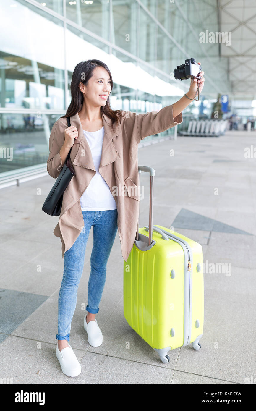 Woman taking selfie by camera in Hong Kong airport Stock Photo - Alamy