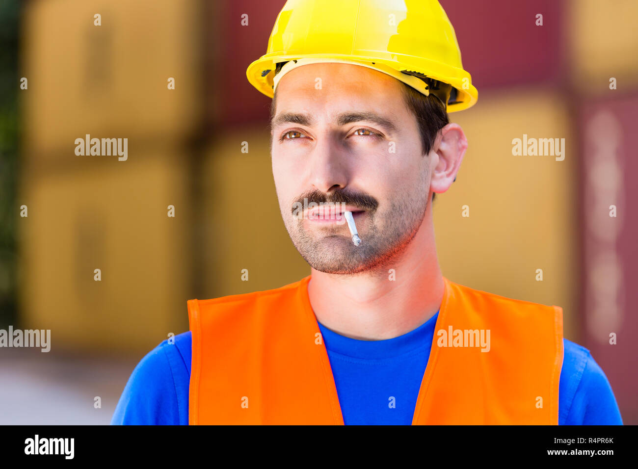 Smoking worker in logistics company with cigarette Stock Photo