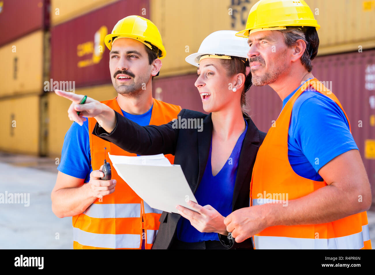 Workers on logistics container port discussing Stock Photo