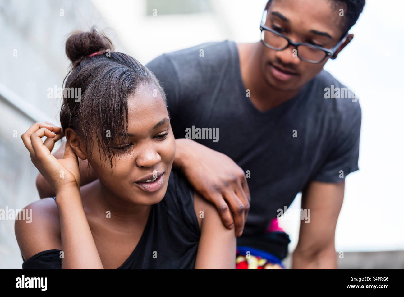 Portrait of young African American couple making funny faces while ...