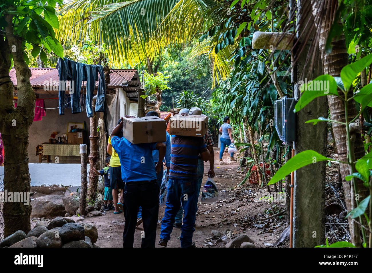 christian missionaries carrying supplies and food to remote village in Guatemalan jungle Stock Photo