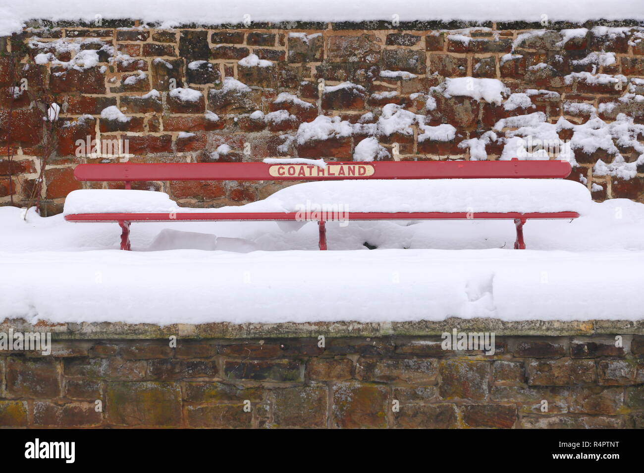 Thick snow covers a bench on the platform at Goathland Station on the North Yorkshire Moors Railway Stock Photo