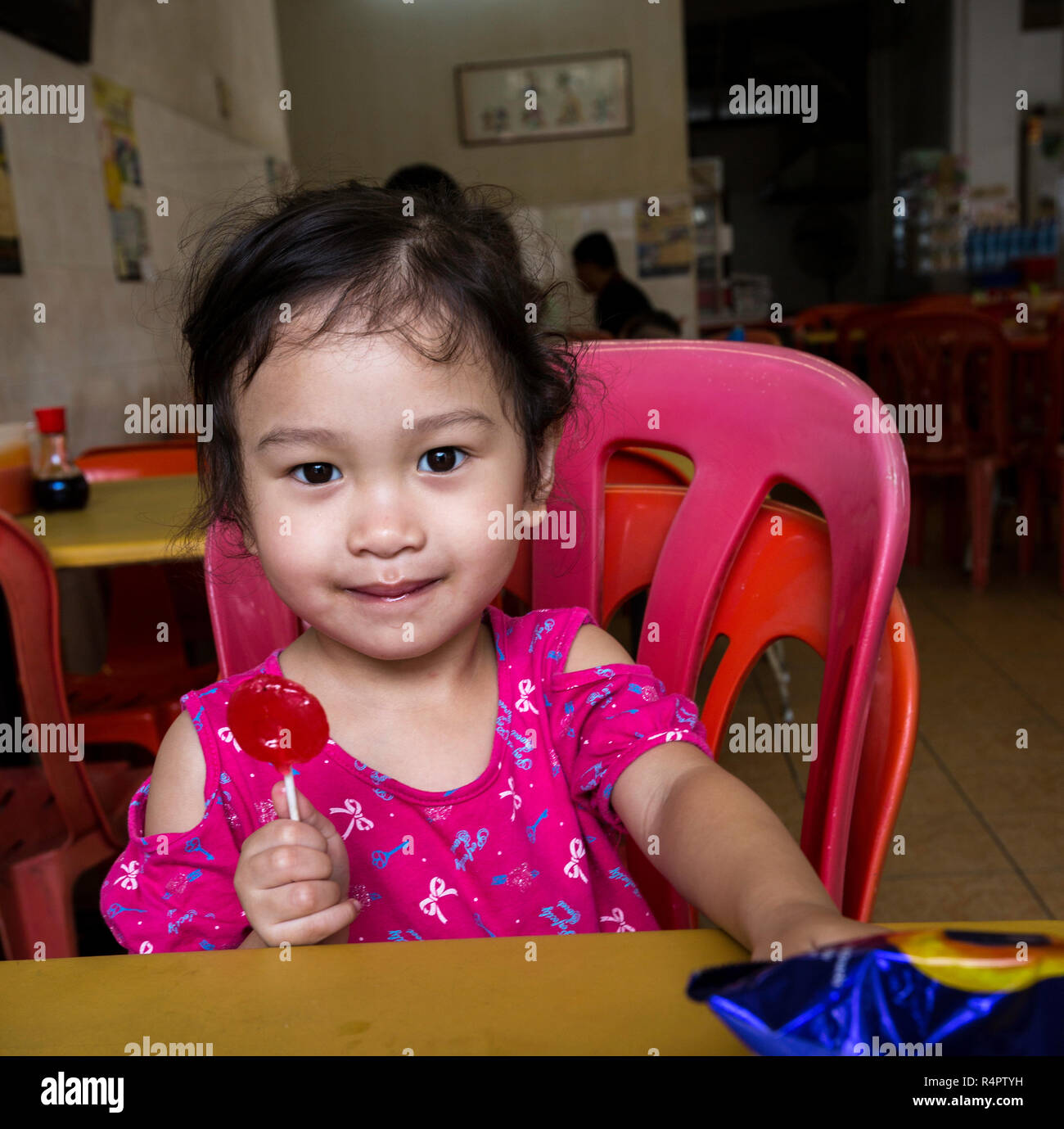 Young Malaysian Girl with Lolipop. Ipoh, Malaysia. Stock Photo