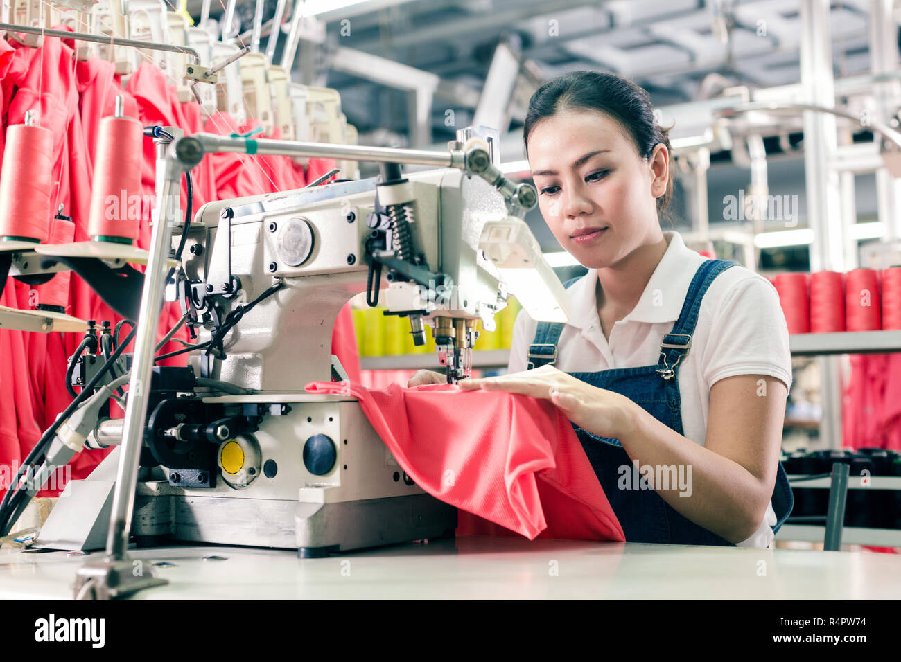 Chinese seamstress working in textile factory Stock Photo