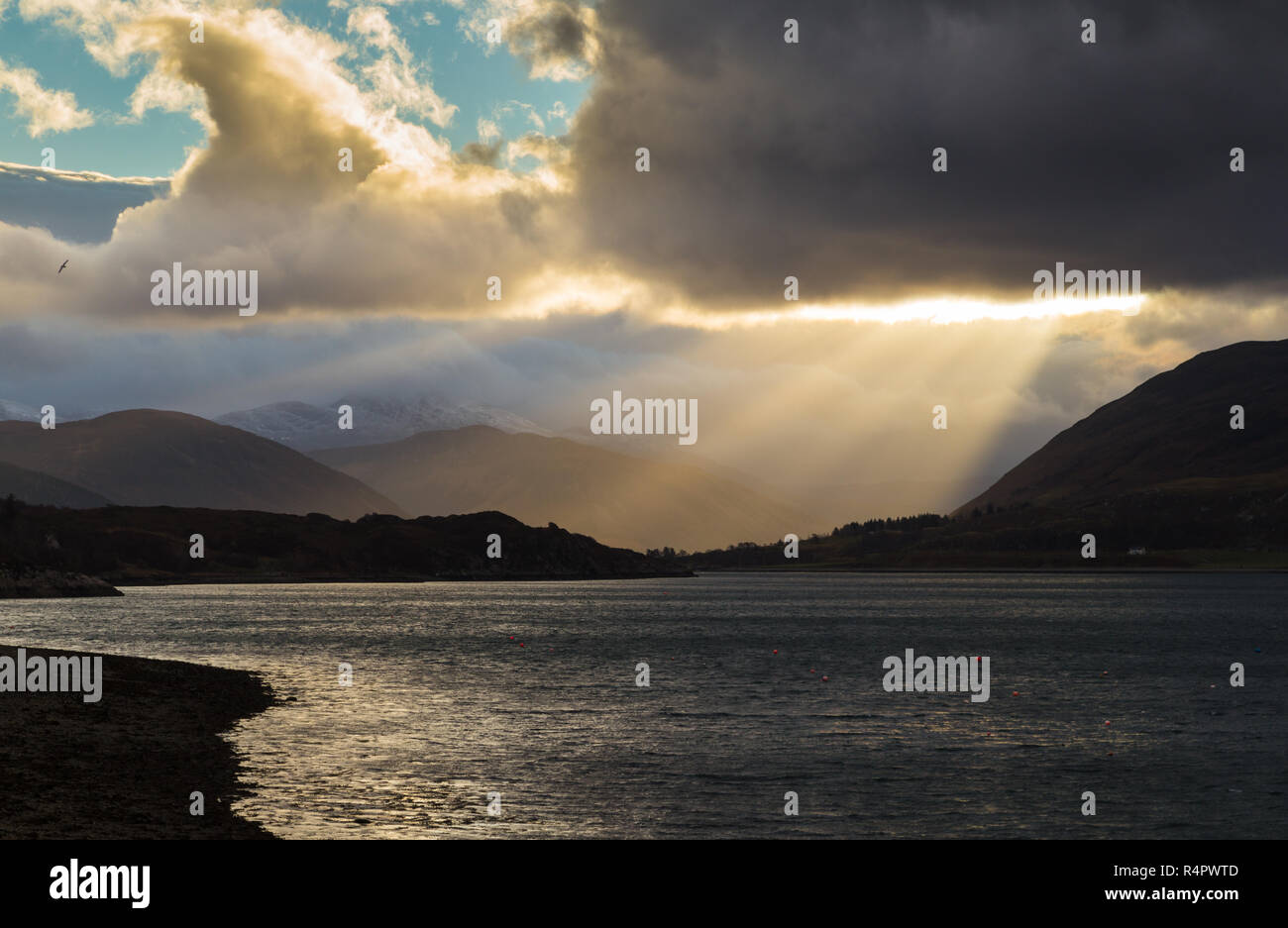 Shafts of sunlight through clouds at the east end of Loch Broom, NW Highlands, Scotland. Viewed from Ullapool. Stock Photo