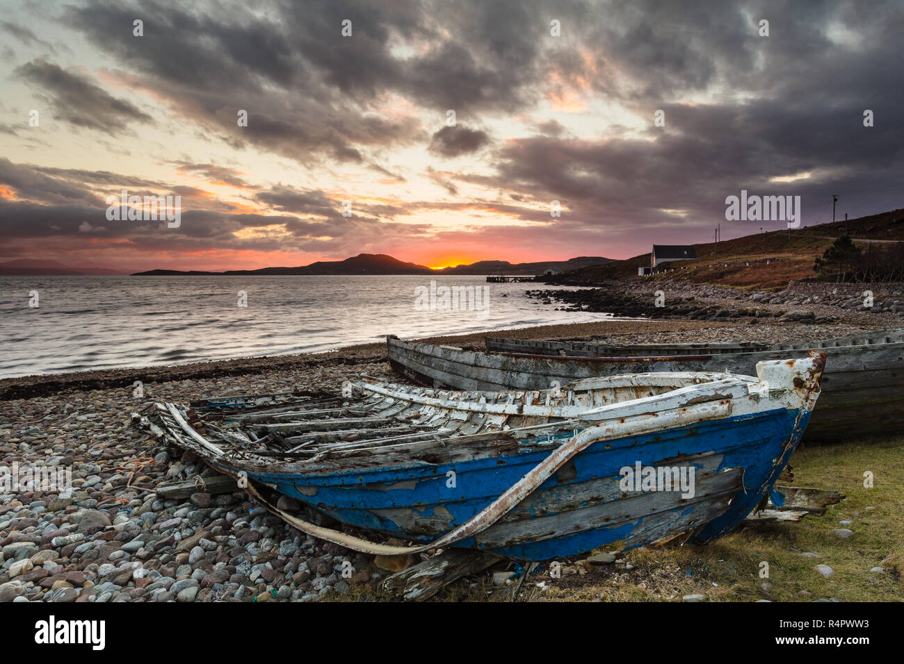 Ruined salmon cobles on the beach at Polbain, Coigach, North West Highlands of Scotland. Stock Photo
