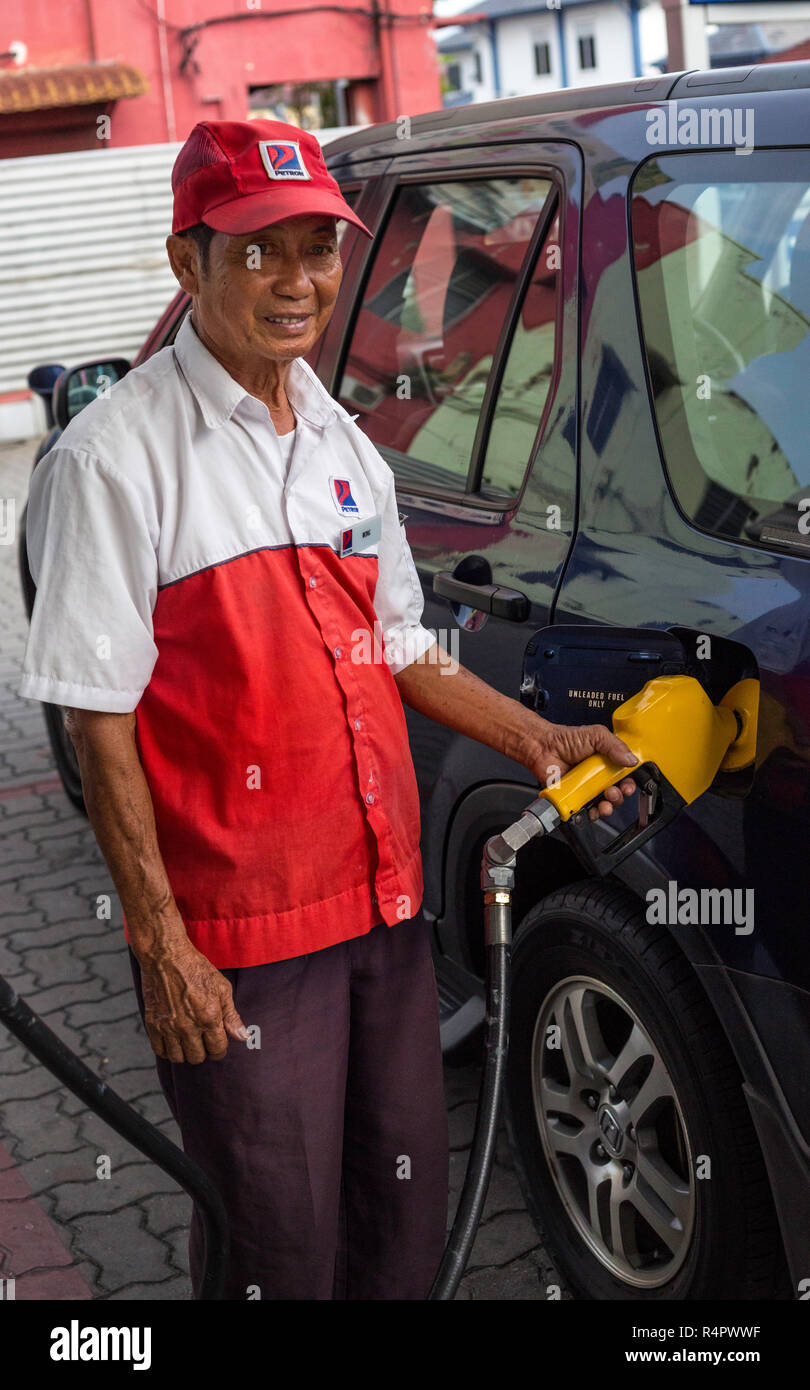 Gas Station Attendant Pumping Gas, Ipoh, Malaysia. Stock Photo