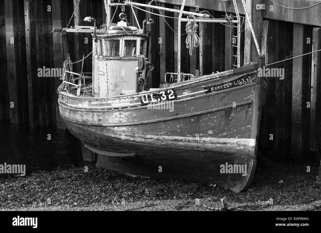 A beached fishing boat by Ullapool pier, North-West Highlands of Scotland. Stock Photo