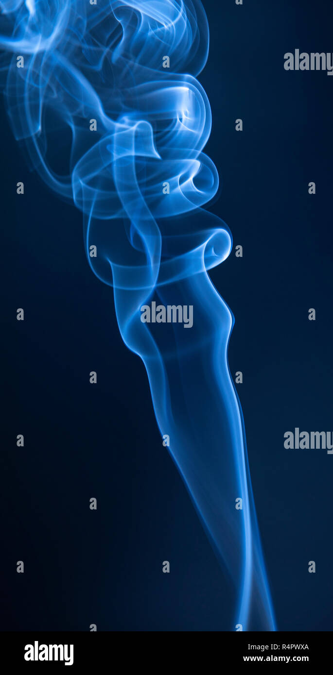 Abstract blue smoke swirls on dark background Stock Photo - Alamy
