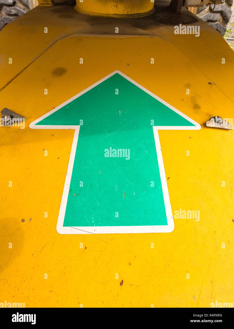green arrow pointing upwards on a machine Stock Photo
