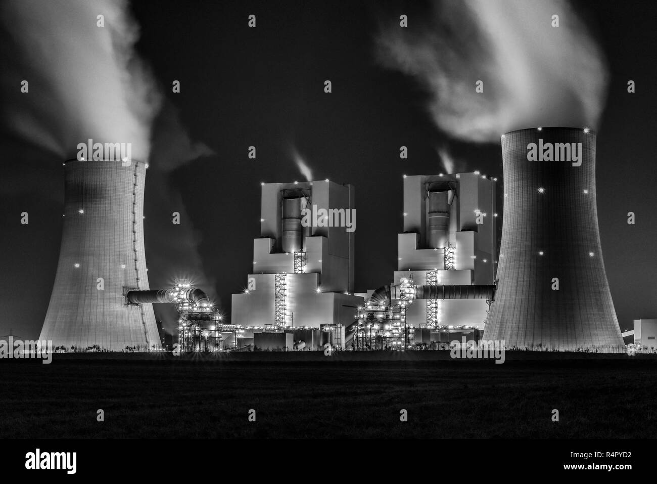 night shot of illuminated lignite power station with cooling towers Stock Photo