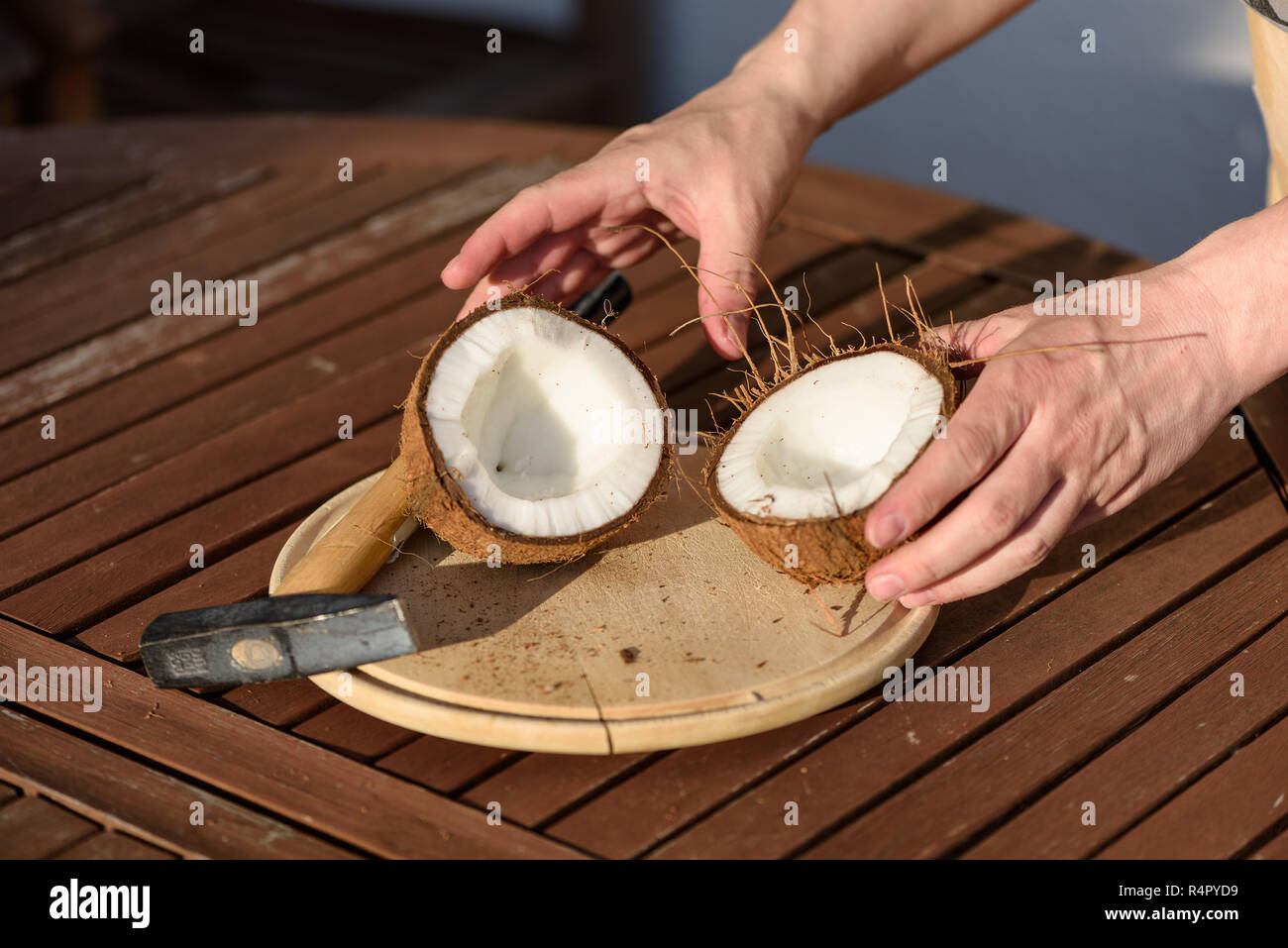 close up on hands hammering a coconut Stock Photo