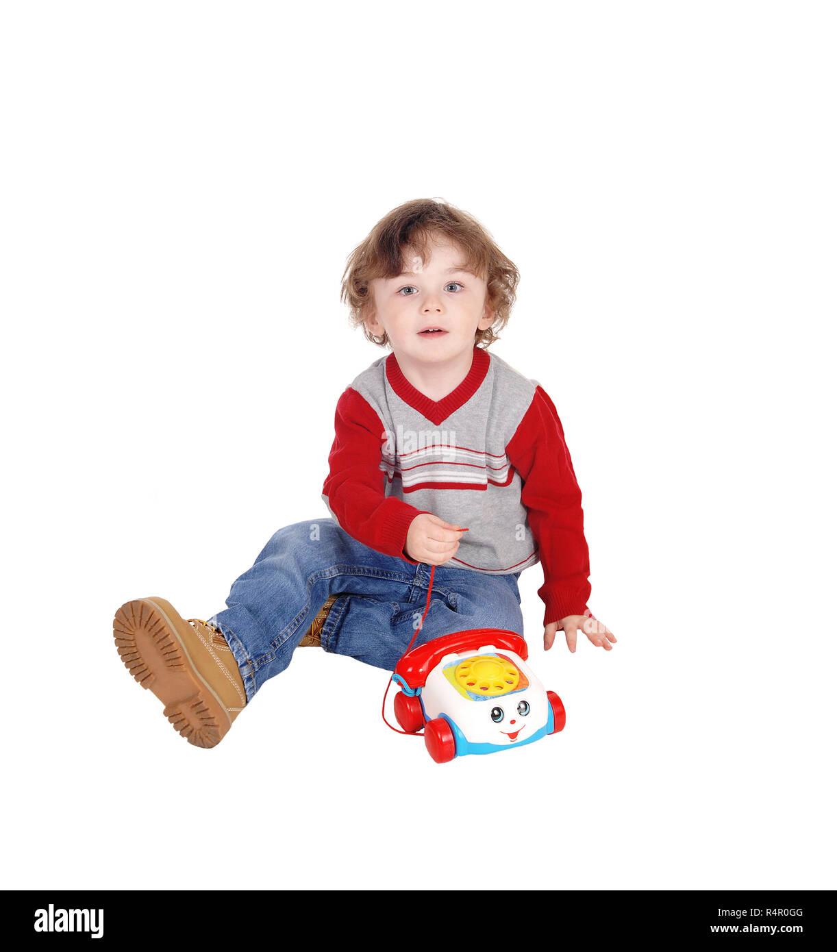 Portrait of little boy with his toy phone. Stock Photo
