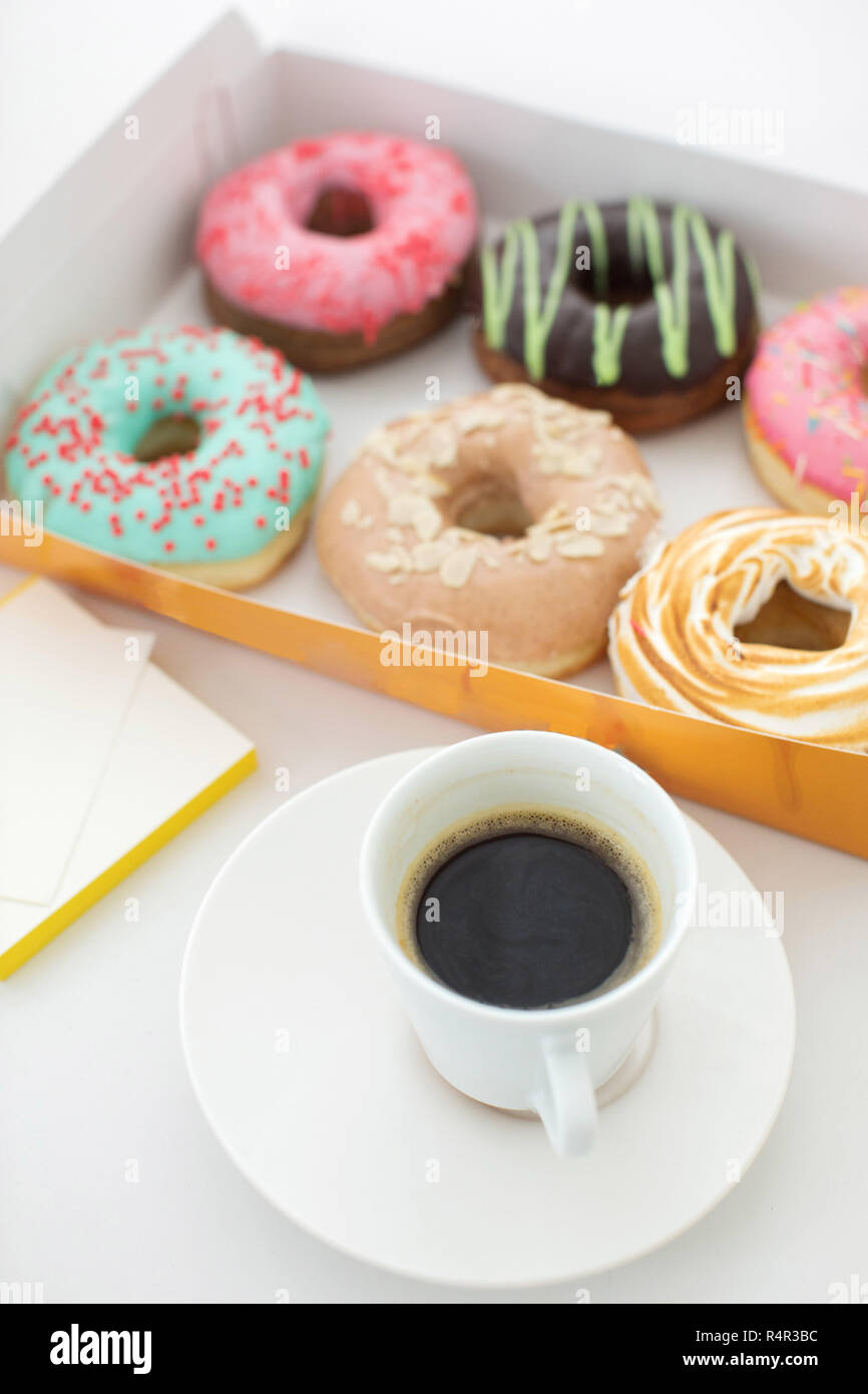 Cup of coffee and box of doughnuts Stock Photo
