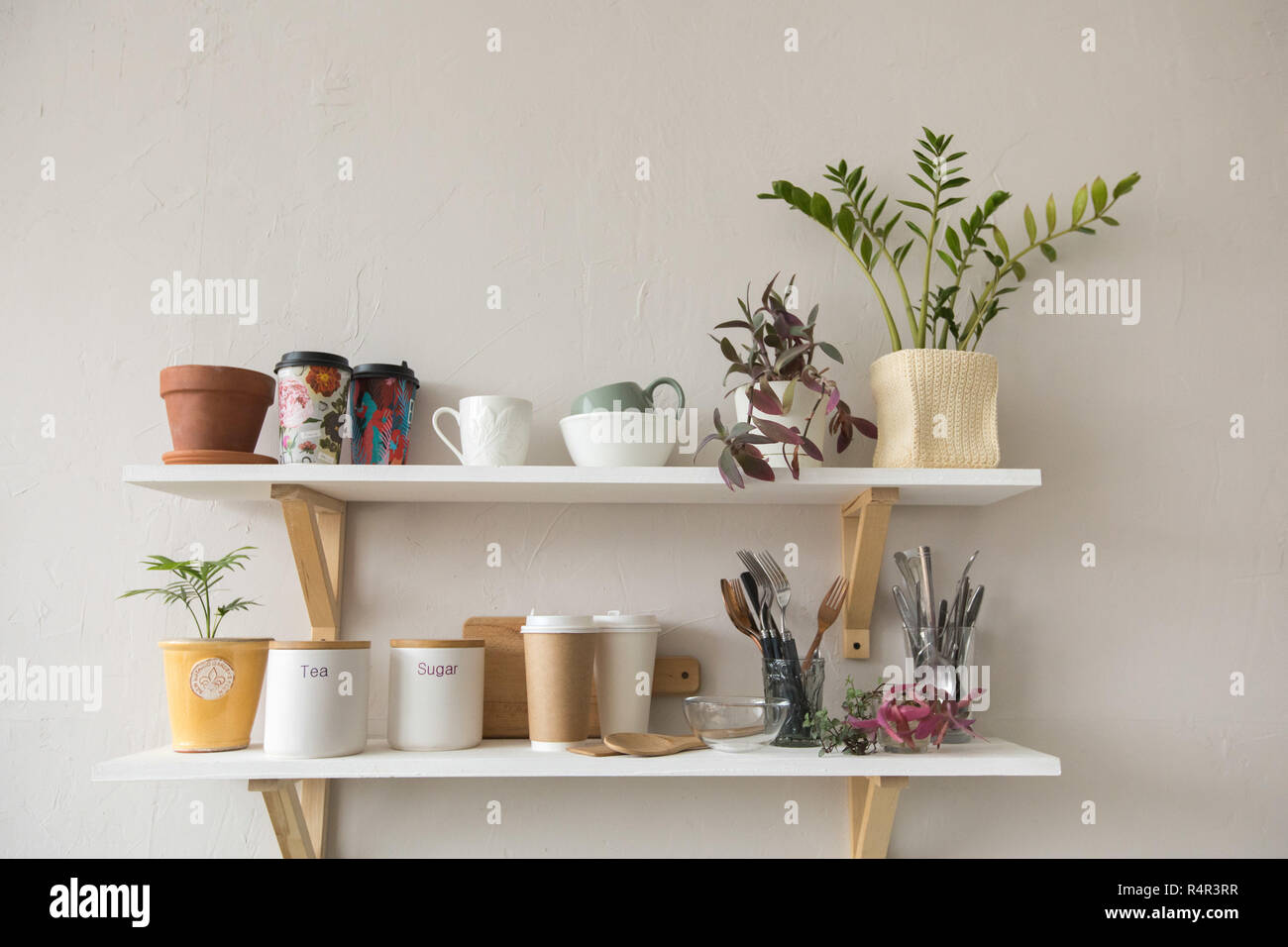 Pots and dishware on shelves Stock Photo