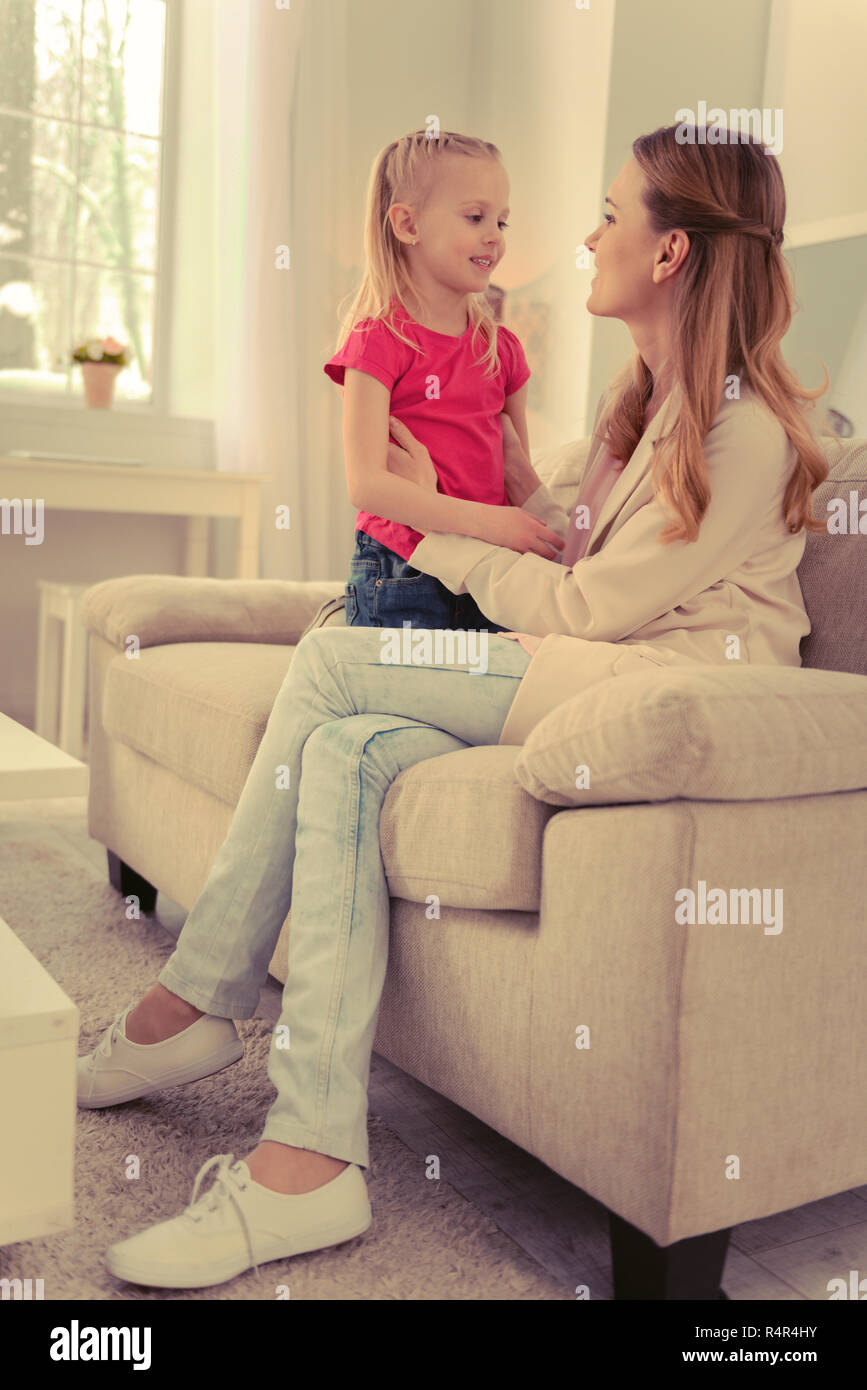 Joyful nice woman sitting on the sofa Stock Photo