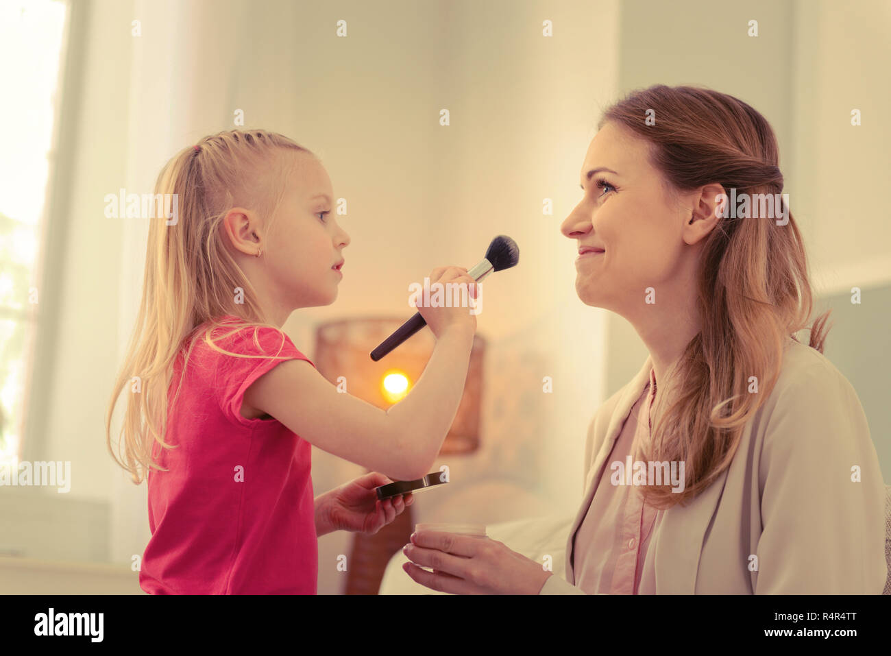 Beautiful blonde girl doing makeup at home hi-res stock photography and ...