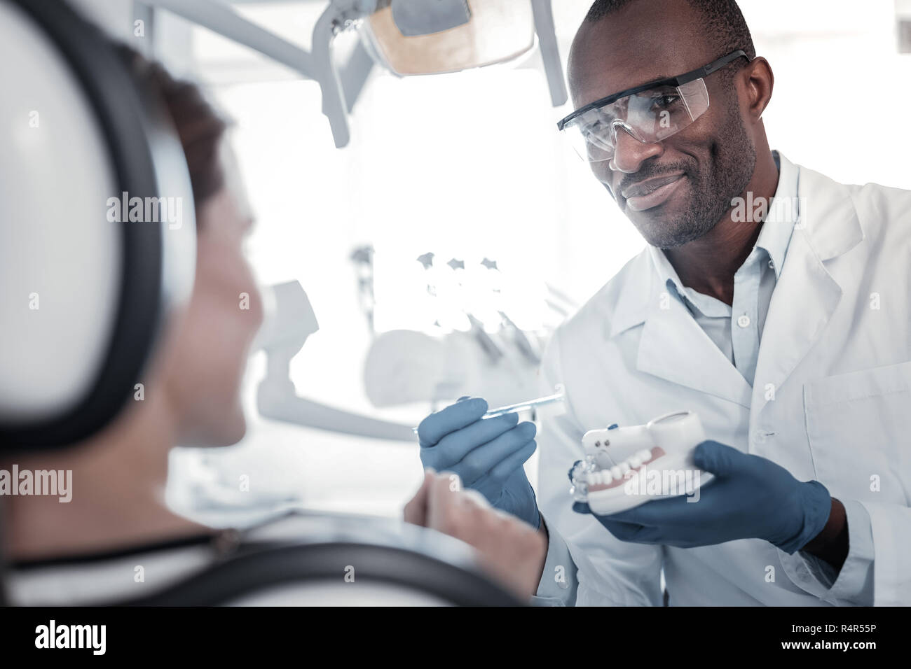 Professional dentist consulting his pretty female patient Stock Photo