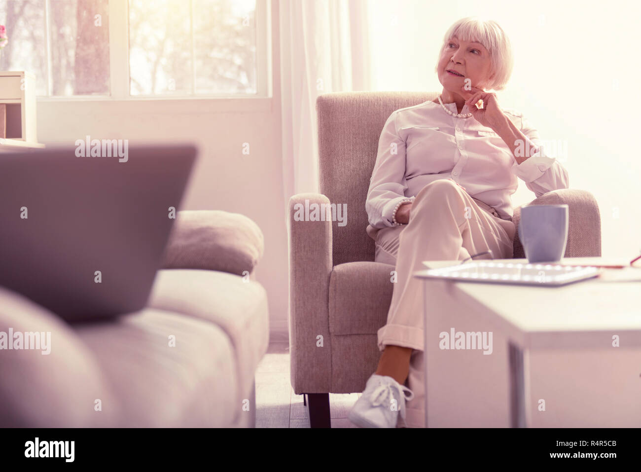 Meditative well-dressed senior lady chilling at home Stock Photo
