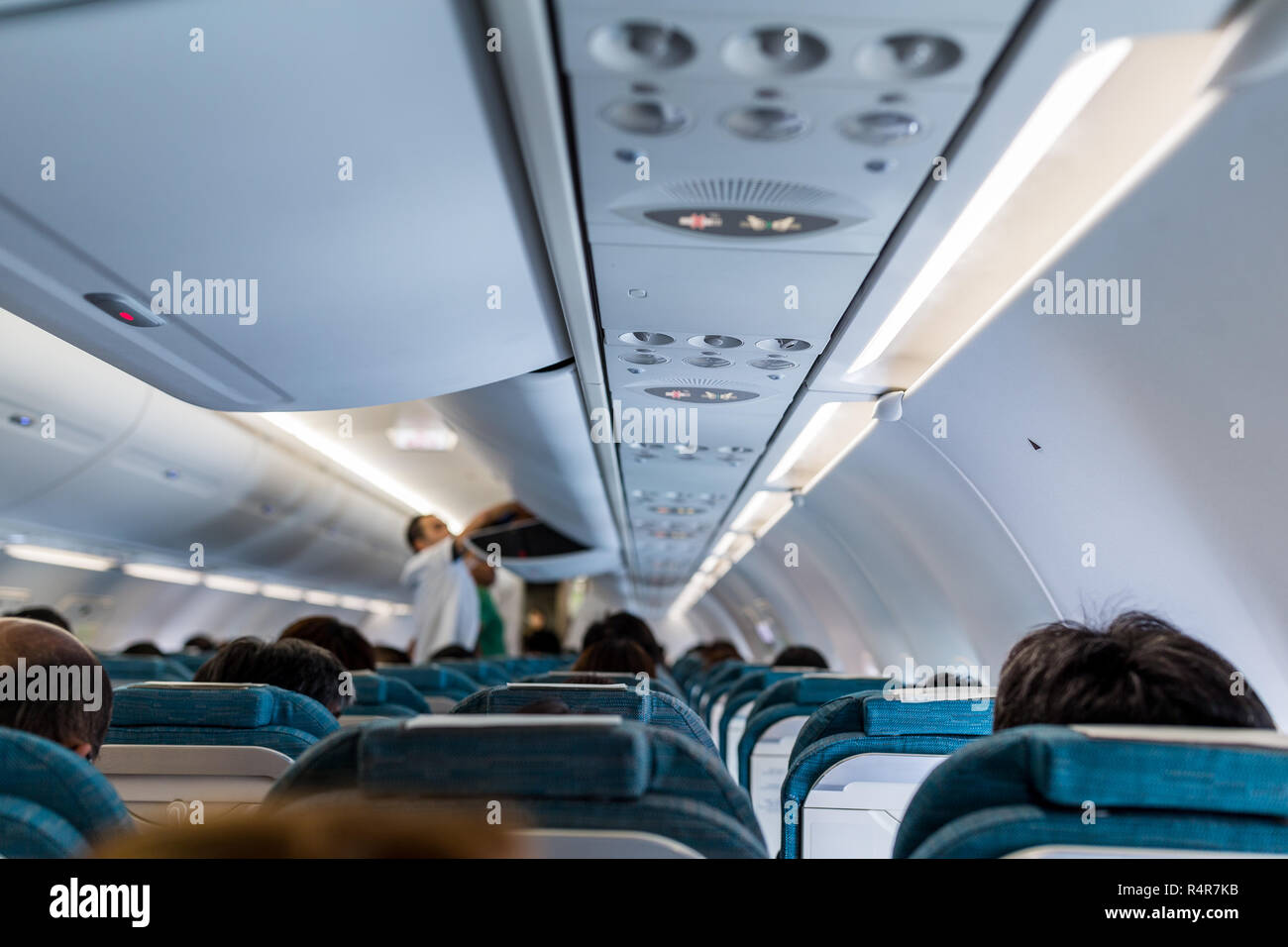 Commercial aircraft cabin with rows of seats down the aisle Stock Photo ...