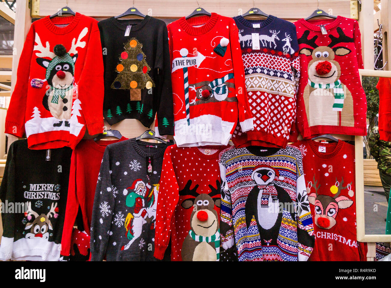 Christmas Jumpers on sale at a market Stock Photo