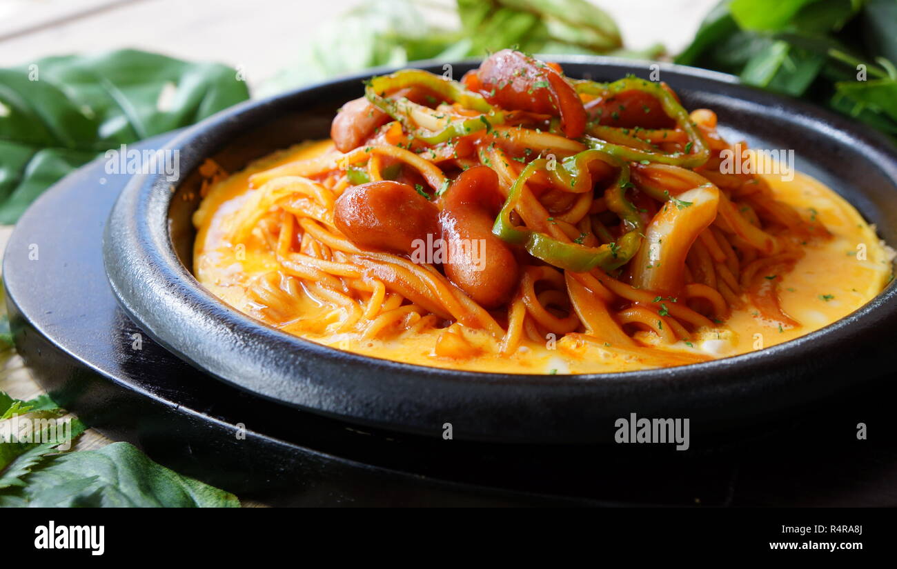 Iron board Napolitan of noodle ramen with cheese and saussages Stock Photo
