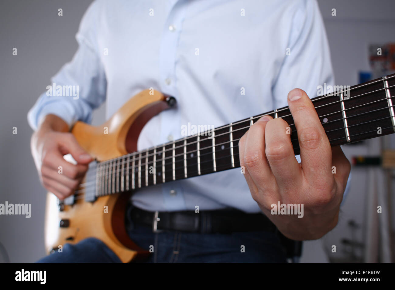 Male arms playing classic shape electric guitar Stock Photo Alamy