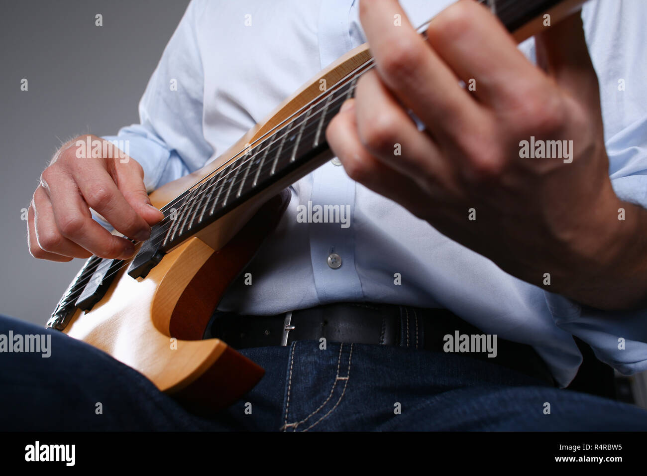 Male arms playing classic shape electric guitar Stock Photo Alamy